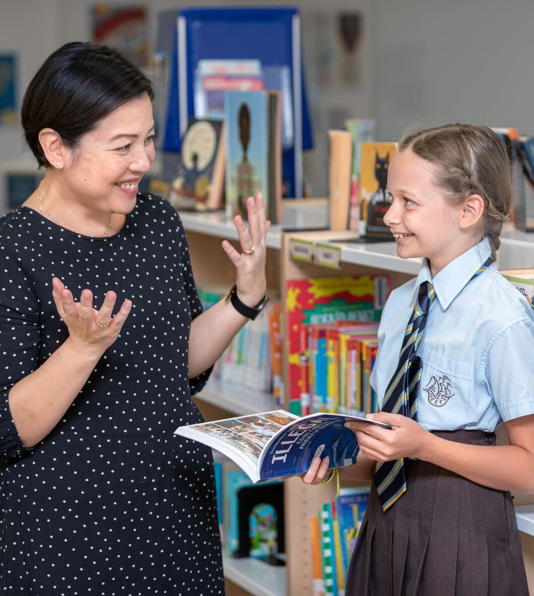 Teacher and student talking. Become a teacher at one of our international schools with NLCS International